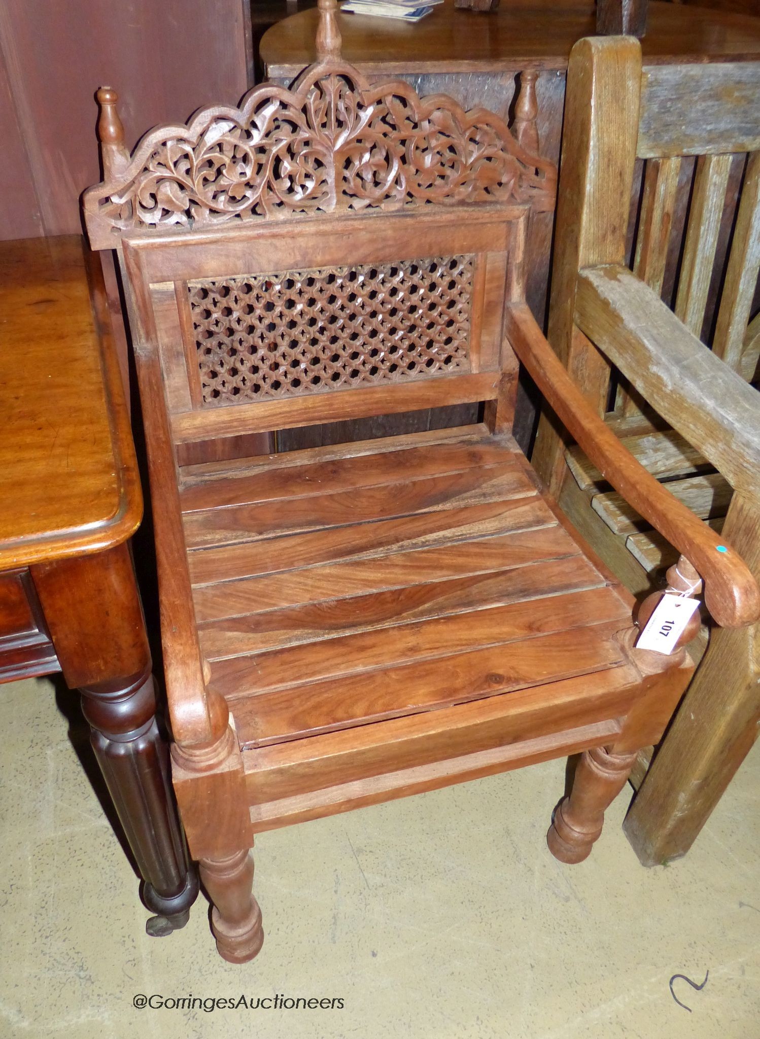 An Anglo-Indian carved hardwood elbow chair, width 55cm, depth 48cm, height 98cm